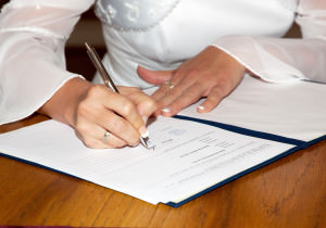 The bride signing the marriage certificate